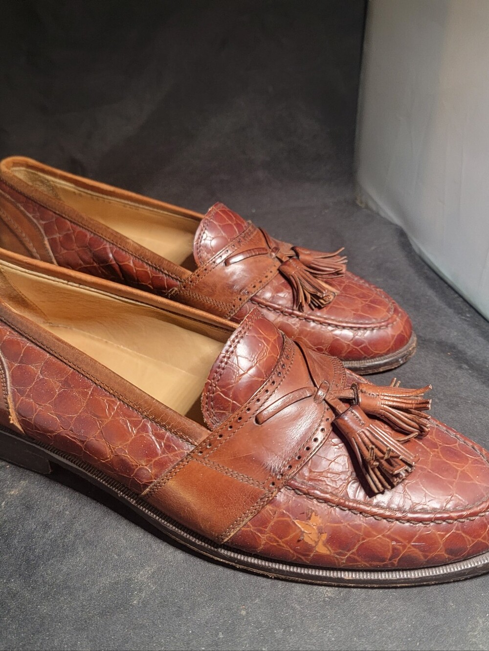 Johnston & Murphy men's tassel loafers featuring a combination of smooth leather